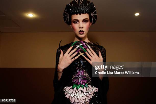 Model showcases designs from the Romance Was Born collection backstage at the University of Sydney during Rosemount Australian Fashion Week...