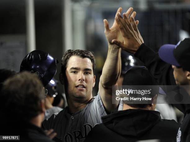 Seth Smith of the Colorado Rockies celebrates his run with teammates for a 3-2 lead over the Los Angeles Dodgers during the fifth inning at Dodger...