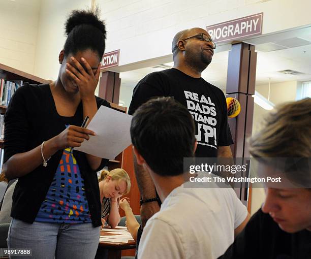 Johne Jones 14, shares poem with Kwame Alexander , founding Director, Book-in-a-Day, on April 30, 2010.