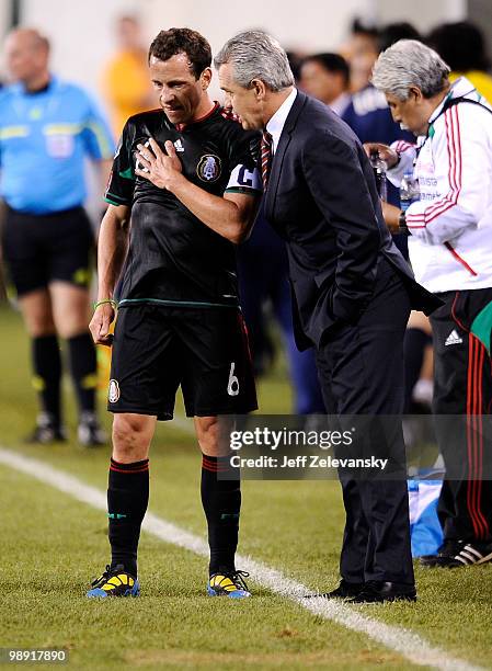 Javier Aguirre, head coach talks with Gerardo Torrado of Mexico during a match against Ecuador in the FMF U.S. Tour at the New Meadowlands Stadium on...