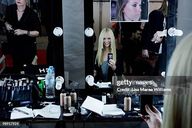 Model takes a photo of herself in a mirror backstage ahead of the Ksubi collection show at the Royal Hall of Industries during Rosemount Australian...