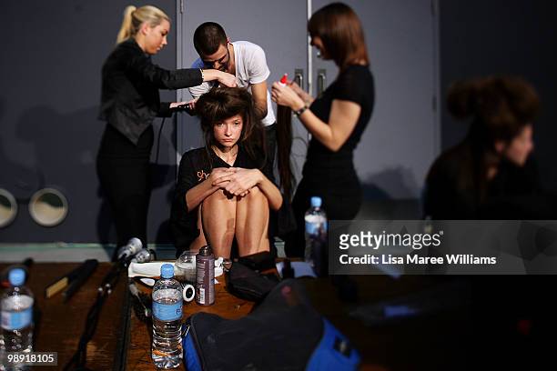 Hairdressers work on a model backstage at Alex Perry's 'Arabian Princess' show at Fox Studios during Rosemount Australian Fashion Week Spring/Summer...