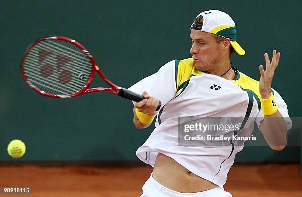 Lleyton Hewitt of Australia plays a forehand during his doubles match against Takao Suzuki and Go Soeda of Japan during the match between Australia...