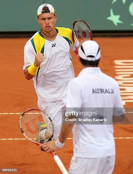 Lleyton Hewitt of Australia celebrates with team mate Paul Hanley during his doubles match against Takao Suzuki and Go Soeda of Japan during the...