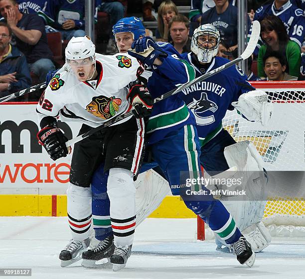 Tomas Kopecky of the Chicago Blackhawks battles for position in front of the net with Sami Salo of the Vancouver Canucks in Game Four of the Western...