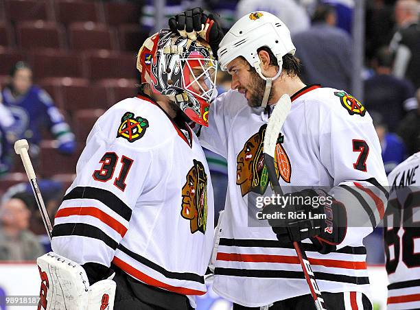 Goalie Antti Niemi of the Chicago Blackhawks is congratulated by Brent Seabrook after they defeated the Vancouver Canucks in Game Four of the Western...