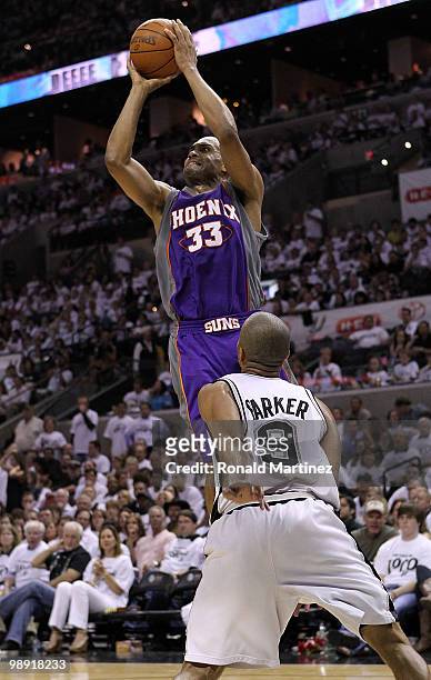 Forward Grant Hill of the Phoenix Suns takes a shot against Tony Parker of the San Antonio Spurs in Game Three of the Western Conference Semifinals...