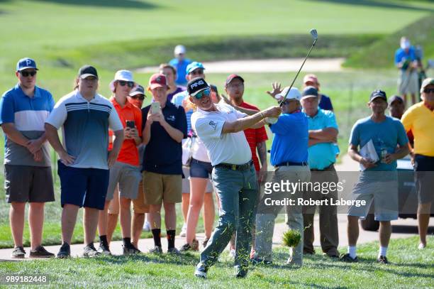 Miguel Angel Jimenez of Spain makes a shot out of the rough on the 14th hole during the final round of the U.S. Senior Open Championship at The...