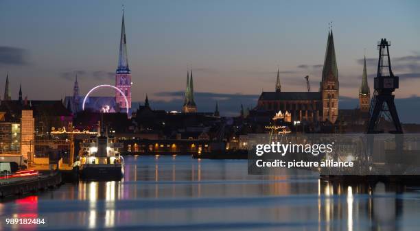 The ferris wheel turns round and round at the Christmas market at Koberg in the historic inner city of Luebeck, Germany, 16 December 2017. The...