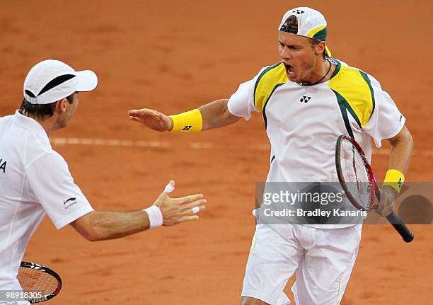 Lleyton Hewitt of Australia and Paul Hanley of Australia celebrate winning a point during their doubles match against Takao Suzuki and Go Soeda of...