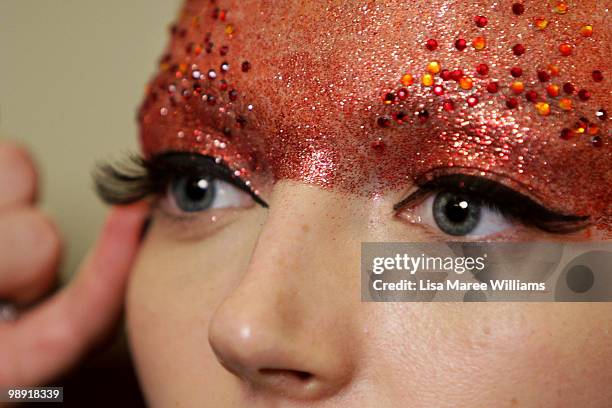 Model Louise Van de Vorst has make-up applied in preparation for the Romance Was Born collection show at the University of Sydney during Rosemount...