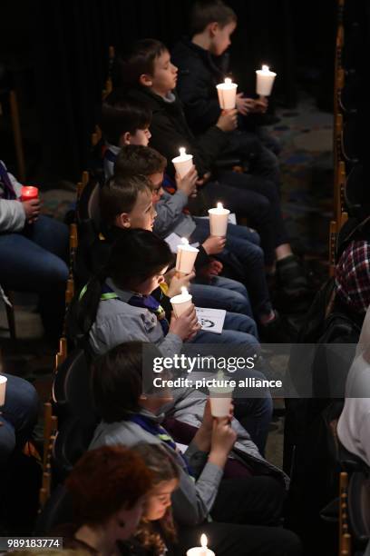 Church-gooers holding Bethlehem's light of peace as a sign against terrorism and violence in the Kaiser Wilhelm Memorial Church in Berlin, Germany,...