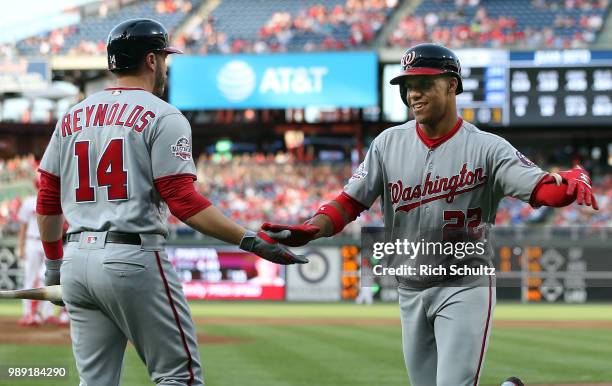 Juan Soto of the Washington Nationals is congratulated by Mark Reynolds after hitting a two-run home run during the first inning of a game against...