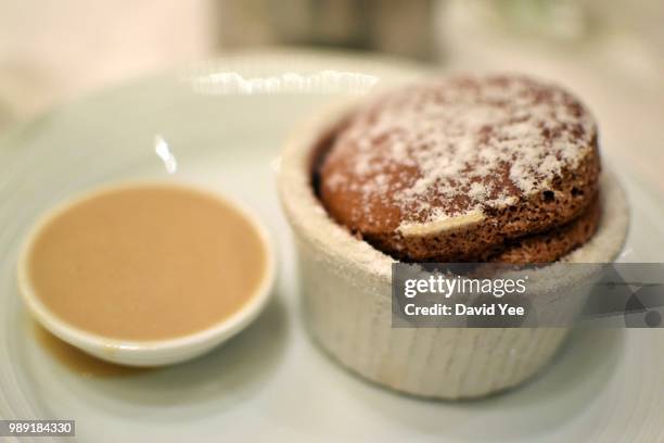 bittersweet chocolate souffle with expresso sauce - chocolate souffle stock pictures, royalty-free photos & images