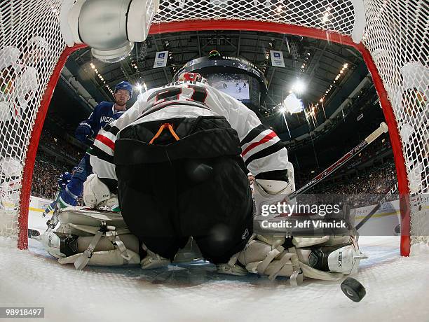 Henrik Sedin of the Vancouver Canucks looks on as his shot gets past Antti Niemi of the Chicago Blackhawks for a goal in Game Four of the Western...