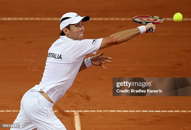 Paul Hanley of Australia plays a backhand volley in his doubles match against Takao Suzuki and Go Soeda of Japan during the match between Australia...