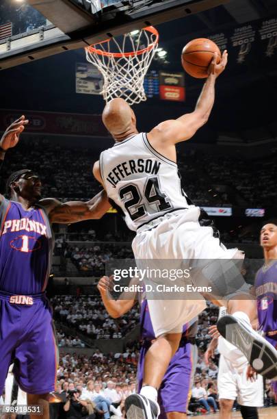 Richard Jefferson of the San Antonio Spurs shoots a reverse layup against Amar'e Stoudemire of the Phoenix Suns in Game Three of the Western...