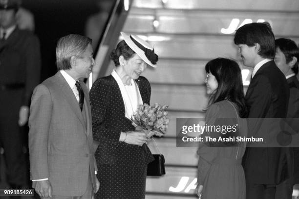 Crown Prince Akihito and Crown Princess Michiko are welcomed by Prince Naruhito, Prince Fumihito and Princess Sayako on arrival at Haneda Airport on...