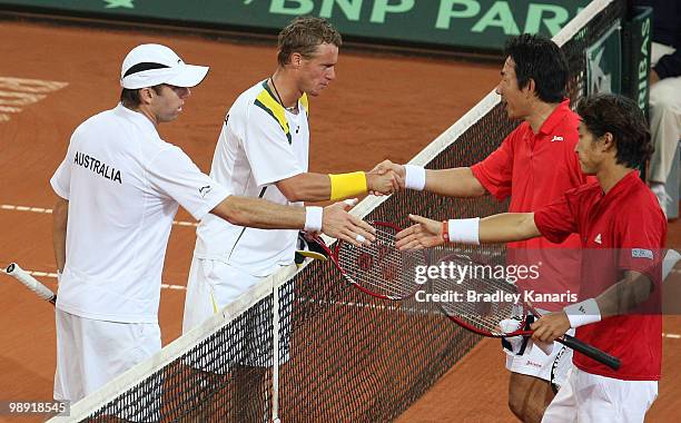 Lleyton Hewitt and Paul Hanley of Australia shake hands with Takao Suzuki and Go Soeda of Japan after winning their doubles match between Australia...