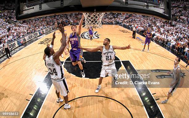 Gordan Dragic of the Phoenix Suns shoots against Antonio McDyess and Tim Duncan of the San Antonio Spurs in Game Three of the Western Conference...