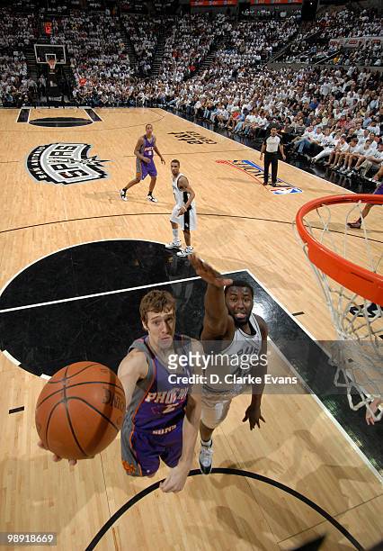 Gordan Dragic of the Phoenix Suns shoots against DeJuan Blair of the San Antonio Spurs in Game Three of the Western Conference Semifinals during the...