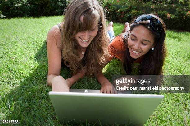 lady and teenage girl using  laptop in park - paul mansfield photography stock pictures, royalty-free photos & images