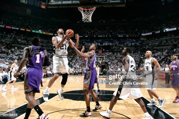 Tim Duncan the San Antonio Spurs fights for a rebound with Channing Frye of the Phoenix Suns in Game Three of the Western Conference Semifinals...