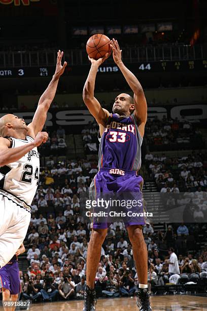 Grant Hill of the Phoenix Suns shoots over Richard Jefferson of the San Antonio Spurs in Game Three of the Western Conference Semifinals during the...
