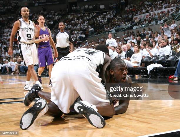 Jason Richardson of the Phoenix Suns is tied up with Antonio McDyess of the San Antonio Spurs in Game Three of the Western Conference Semifinals...