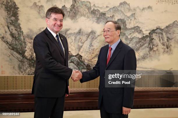 President of the United Nations General Assembly Miroslav Lajcak, left, shakes hands with Chinese Vice President Wang Qishan before their meeting at...