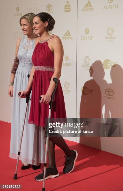 Beach volleyball players Kira Walkenhorst and Laura Ludwig walk across the red carpet at the Kurhaus for the election of "Athlete of the year" in...