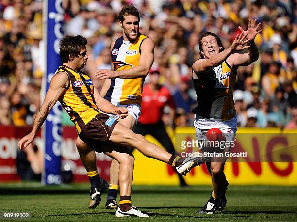 Chance Bateman of the Hawks kick is smothered by Patrick McGinnity of the Eagles during the round seven AFL match between the West Coast Eagles and...