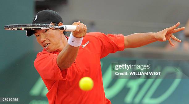 Japan's Takao Suzuki hits a forehand return as he and Go Soeda lose to Australia's Lleyton Hewitt and Paul Hanely, during their Davis Cup tennis tie...