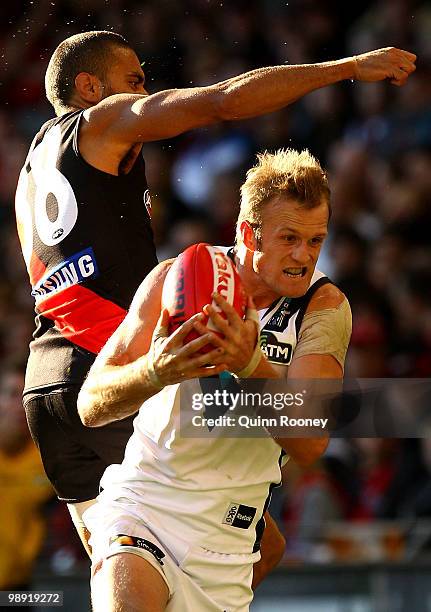 Dean Brogan of the Power marks infront of Jarrod Atkinson of the Bombers during the round seven AFL match between the Essendon Bombers and the Port...