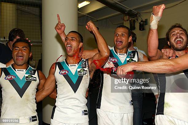 David Rodan, Danyle Pearce, Daniel Motlop and Tom Logan of the Power sing the song in the rooms after winning the round seven AFL match between the...