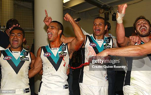 David Rodan, Danyle Pearce, Daniel Motlop and Tom Logan of the Power sing the song in the rooms after winning the round seven AFL match between the...