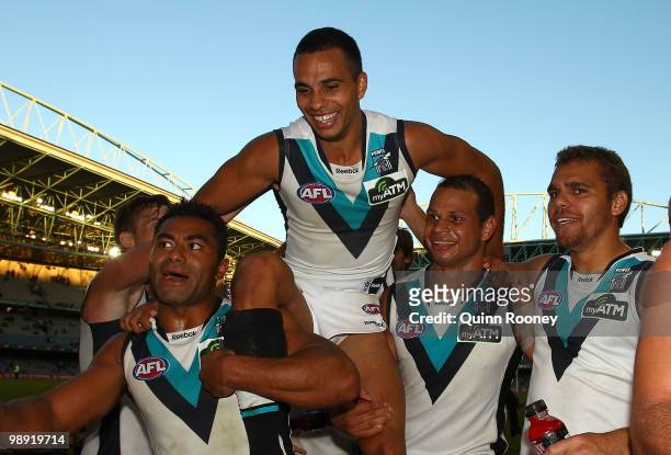 Danyle Pearce of the Power is carried from the ground after playing his 100th game during the round seven AFL match between the Essendon Bombers and...