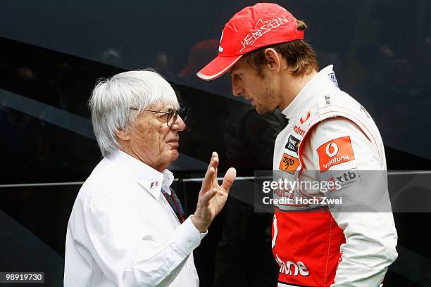 Jenson Button of Great Britain and McLaren Mercedes talks with F1 supremo Bernie Ecclestone as he prepares to drive during practice for the Spanish...