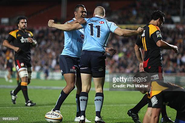 Drew Mitchell of the Waratahs is congratulated on his try by Kurtley Beale during the round 13 Super 14 match between the Chiefs and the Waratahs at...