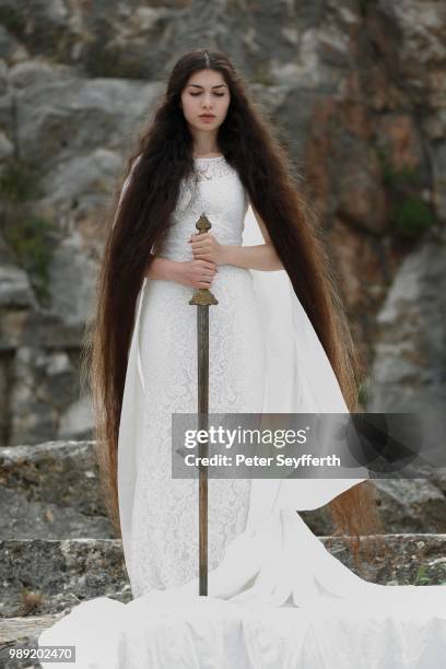 reminiscence to joan of arc, jeanne d'arc, young woman in a white dress with a sword - jeanne darc stock pictures, royalty-free photos & images