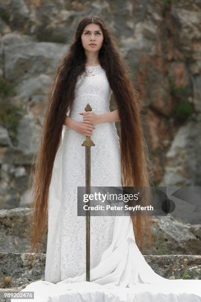 reminiscence to joan of arc, jeanne d'arc, young woman in a white dress with a sword - jeanne darc stock pictures, royalty-free photos & images