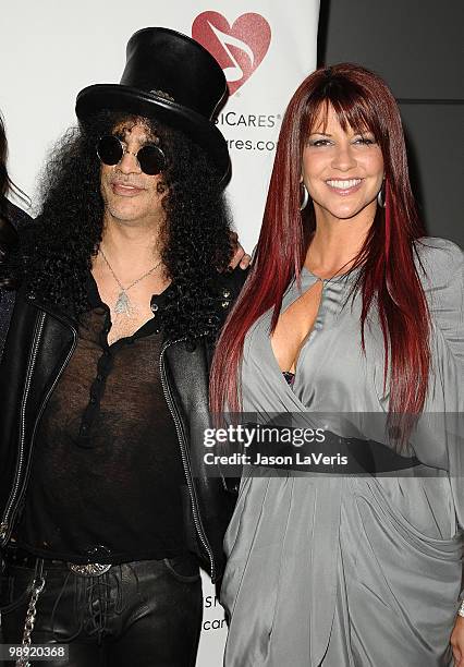 Slash and wife Perla Ferrar attend the 6th annual MusiCares MAP Fund benefit concert at Club Nokia on May 7, 2010 in Los Angeles, California.