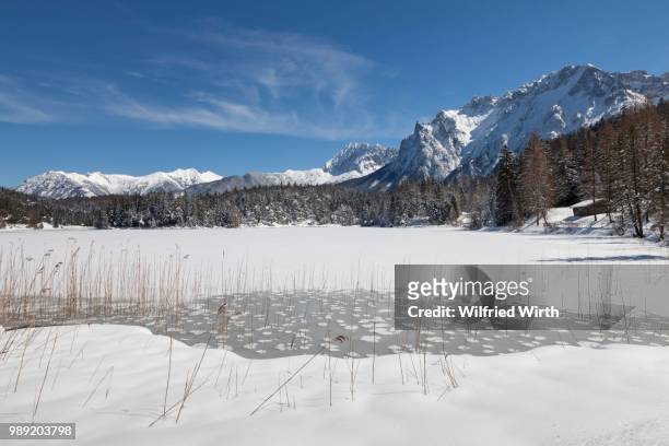 frozen lake lautersee in front of karwendel mountains, near mittenwald, werdenfelser land, upper bavaria, bavaria, germany - werdenfelser land stock pictures, royalty-free photos & images