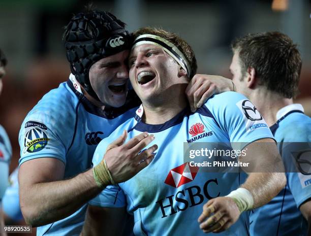 Damien Fitzpatrick of the Waratahs is congratulated on his try by Ben Mowen during the round 13 Super 14 match between the Chiefs and the Waratahs at...