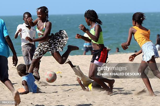 Angolan girls and boys enjoy playing football on the Atlantic ocean beach in Benguela on January 18, 2010 during the African Nations Cup football...