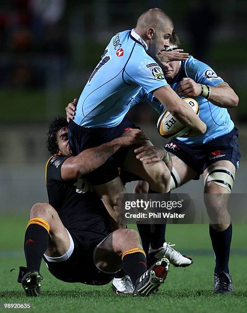 Drew Mitchell of the Waratahs is tackled by Liam Messam of the Chiefs during the round 13 Super 14 match between the Chiefs and the Waratahs at...