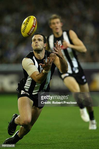 Nathan Brown of the Magpies dives for a mark during the round seven AFL match between the Collingwood Magpies and the North Melboune Kangaroos at...