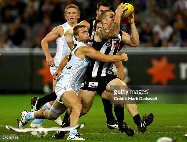 Leigh Adams of the Kangaroos tackles Dane Swan of the Magpies during the round seven AFL match between the Collingwood Magpies and the North Melboune...