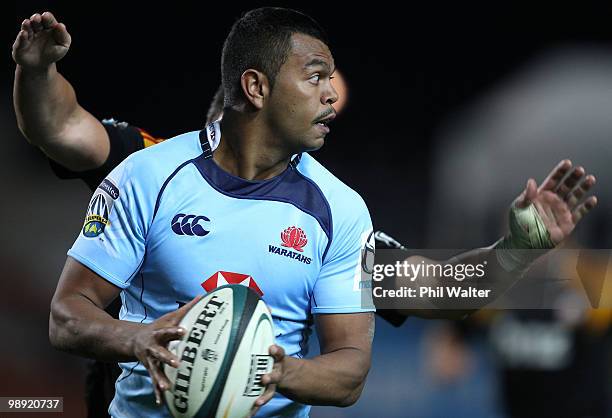 Kurtley Beale of the Waratahs looks to offload the ball during the round 13 Super 14 match between the Chiefs and the Waratahs at Waikato Stadium on...