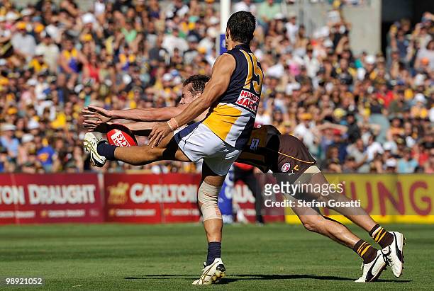 Luke Hodge of the Hawks smothers a kick from Thomas Swift of the Eagles during the round seven AFL match between the West Coast Eagles and the...